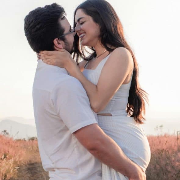 A couple embracing in the evening light, engaged in a calm, emotionally connected moment.