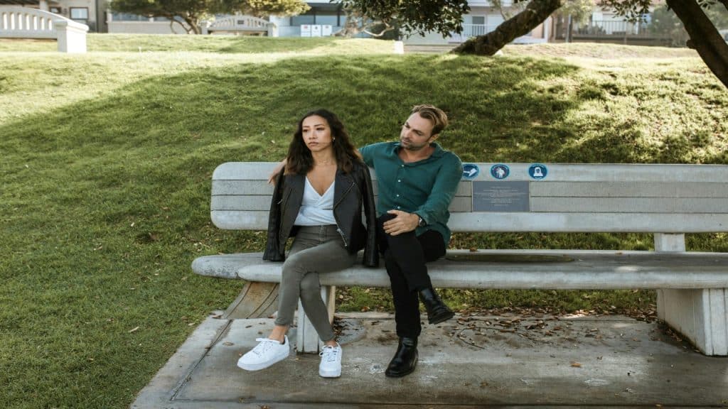 A couple engages in a sincere conversation outdoors, showing how emotional repair can strengthen the connection.