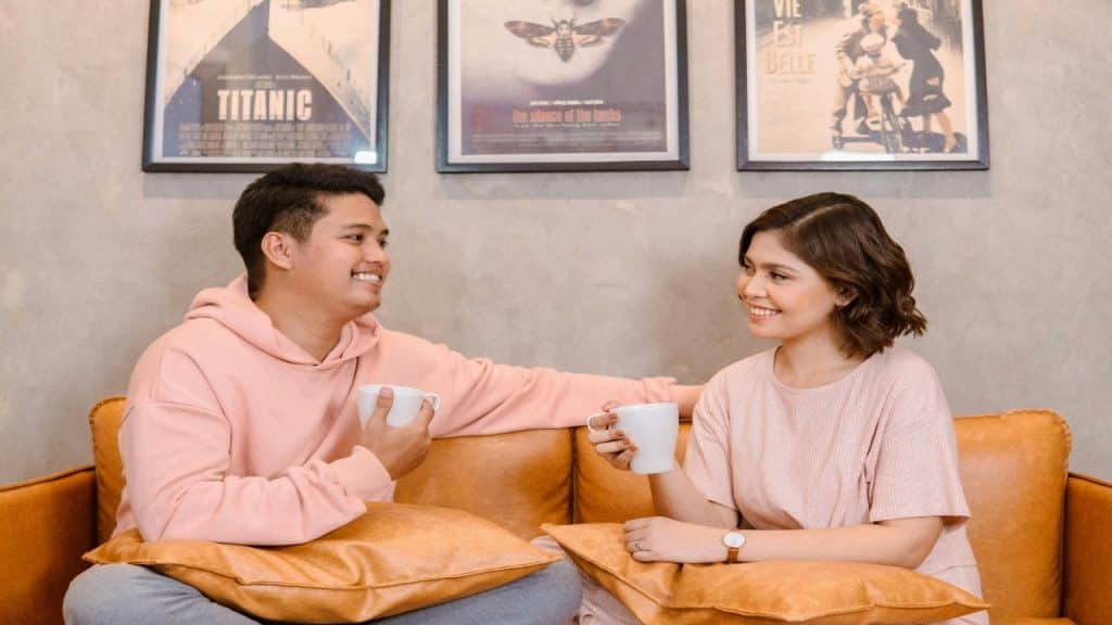 A couple drinking coffee while reconnecting emotionally through eye contact and face-to-face conversation.