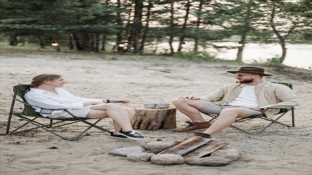 Couple sitting in folding chairs, engaging in meaningful, slow paced conversation