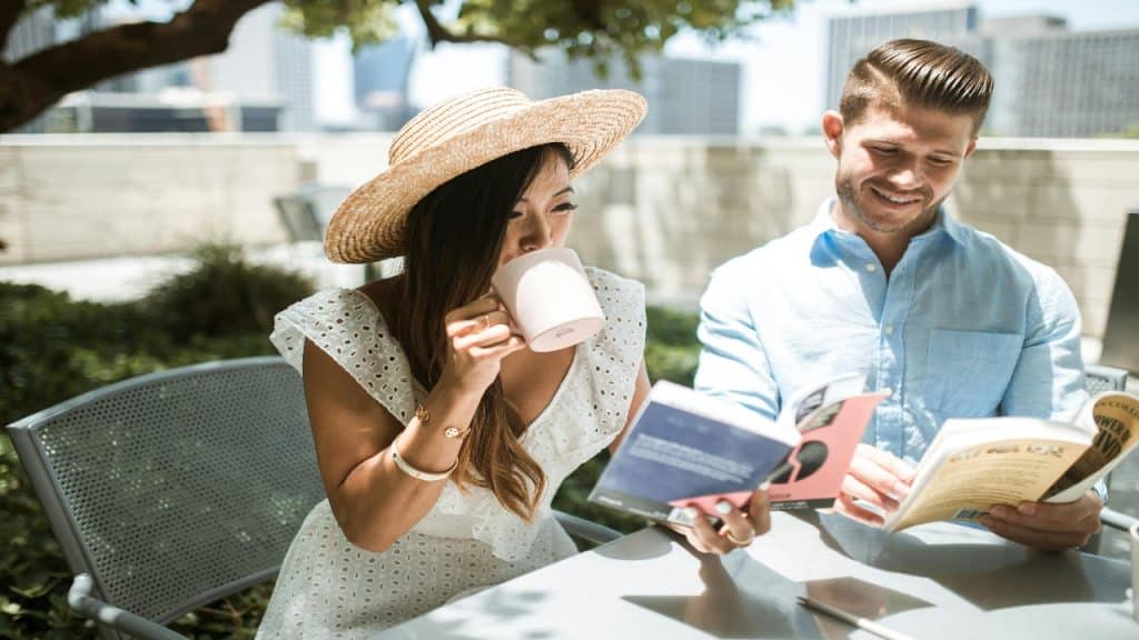 Couple reading books in a coffee shop with a casual connection