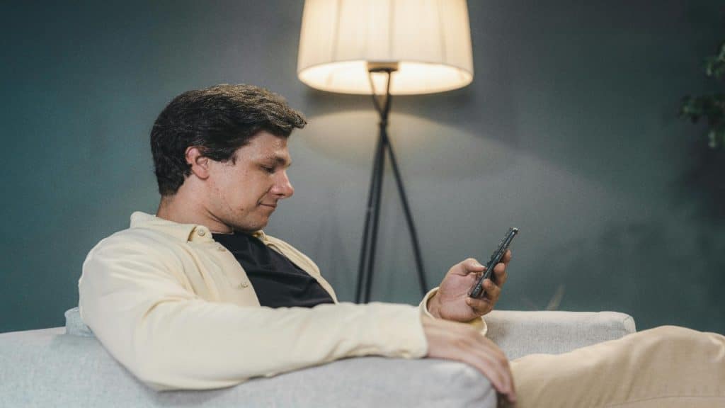 Man scrolling past a social media post of a “perfect couple”