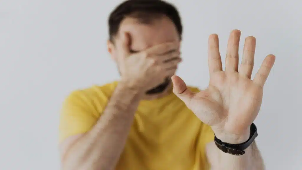 A man covering his eyes and saying “Not the right time for me”