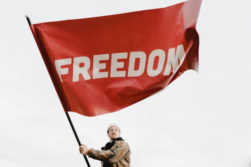 A man holding a flag that says freedom?