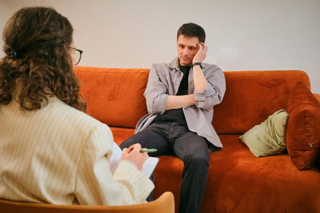 Man silently sitting on the couch