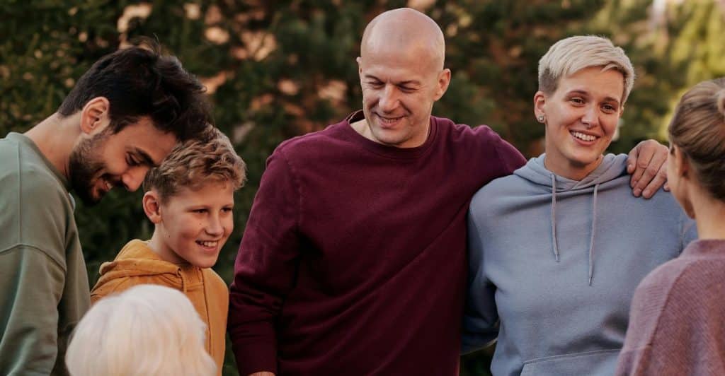 Supportive family members gathered happily honoring each other’s emotional boundaries.