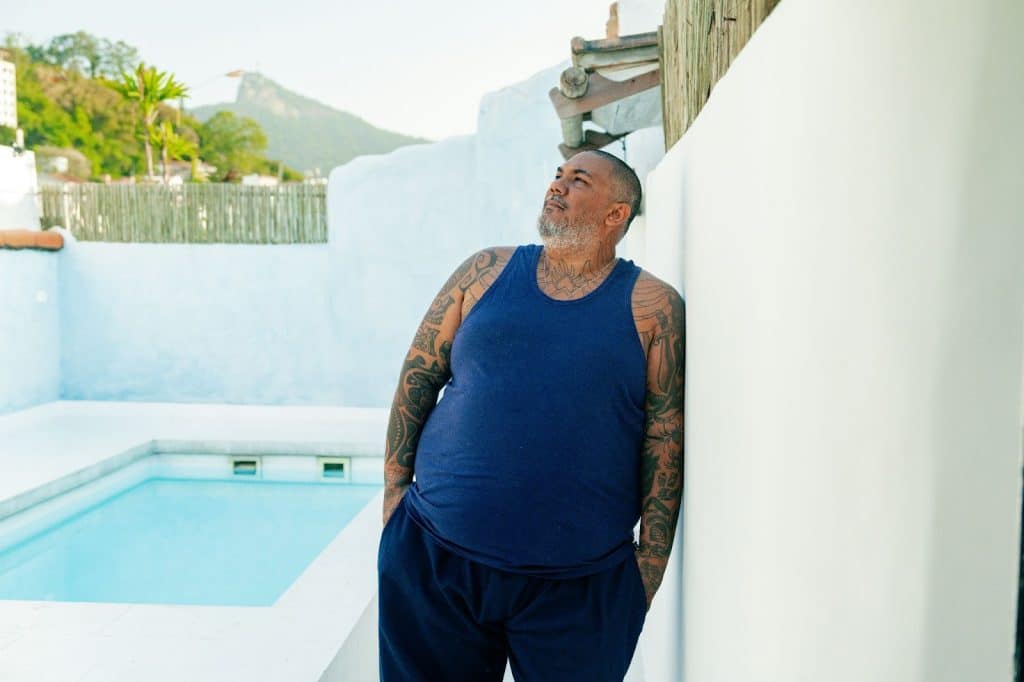 A man standing beside the pool