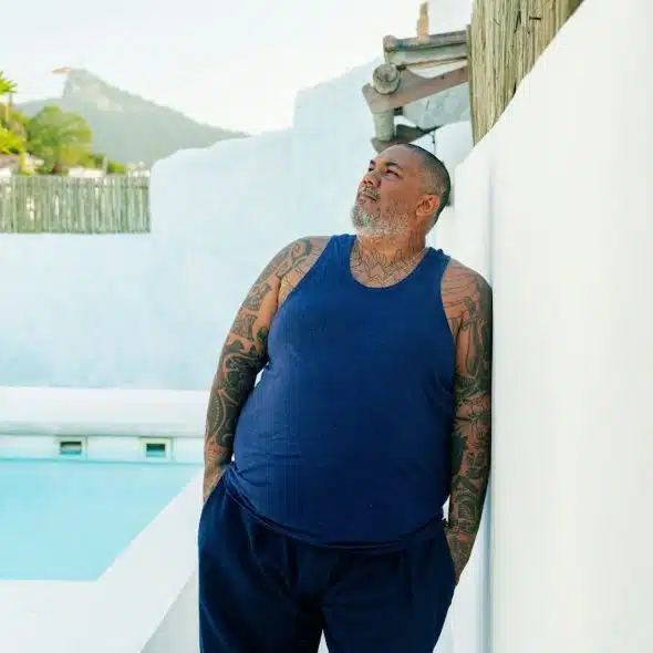 A man standing beside the pool
