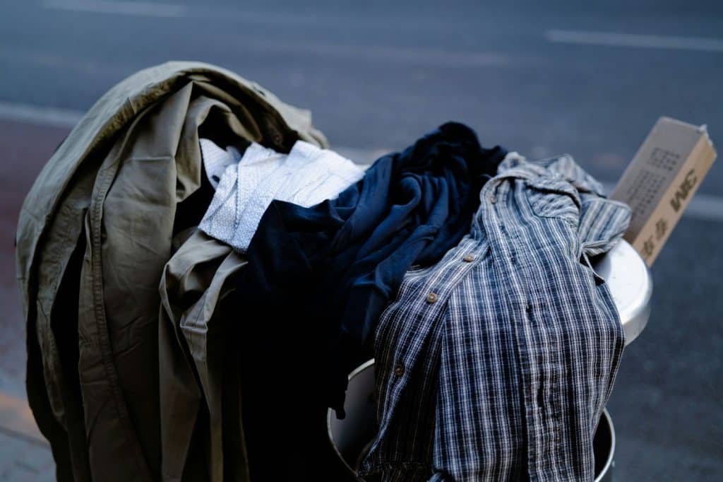 A pile of clothes on trash.