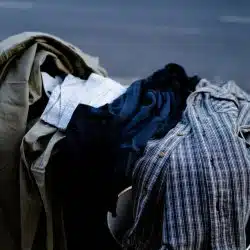 A pile of clothes on trash.
