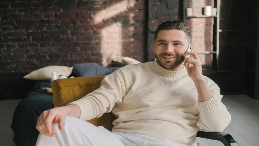 A man on a call speaks openly, engaging in a vulnerable conversation.
