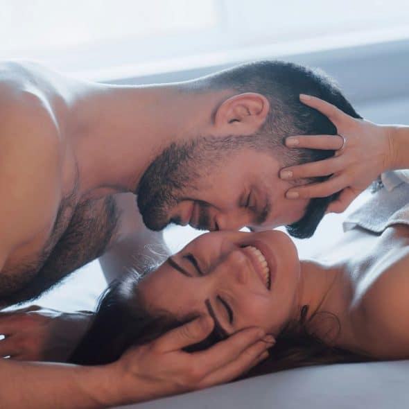 A couple having cuddling at bed