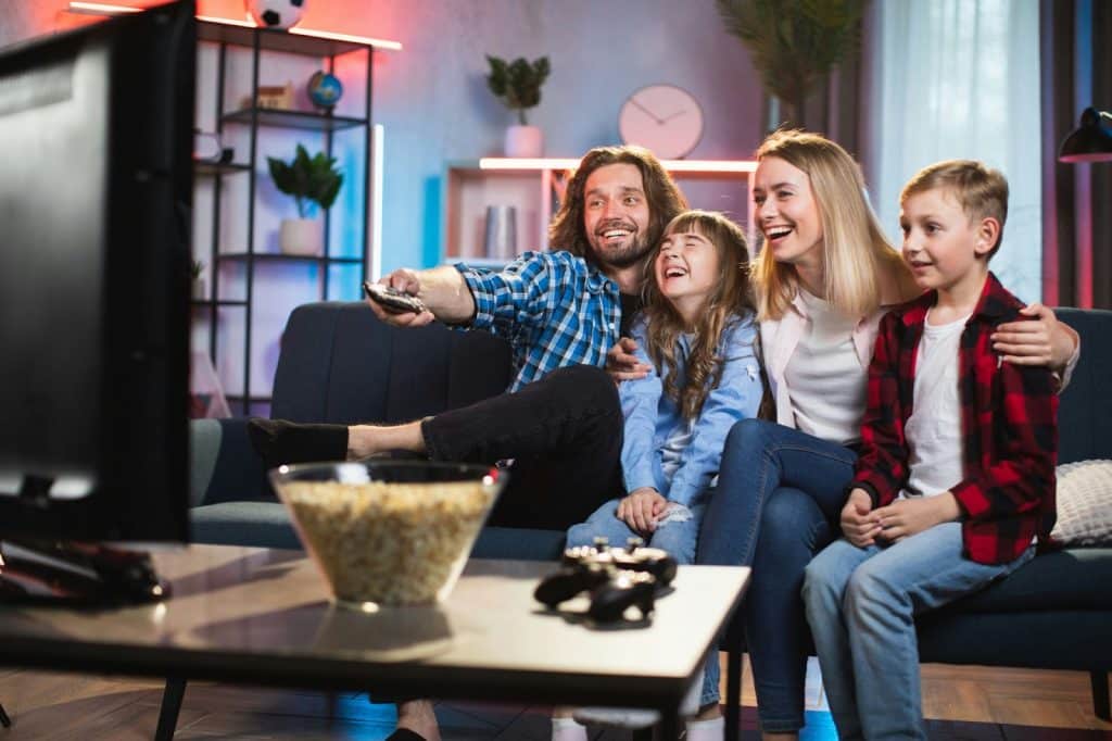 A father watching a movie with his family