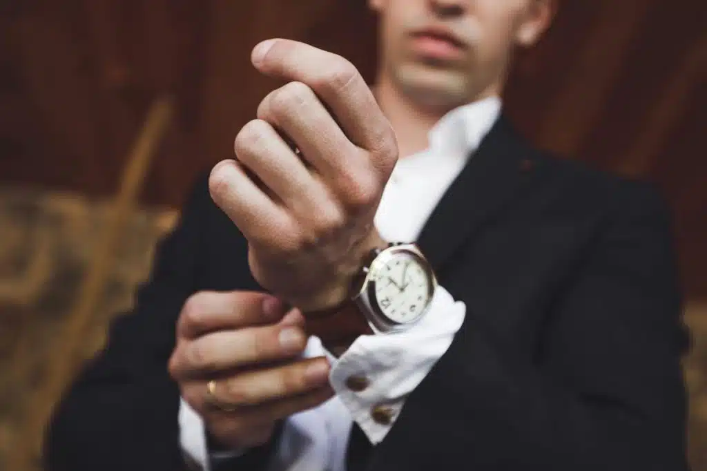 A man showing his wristwatch.