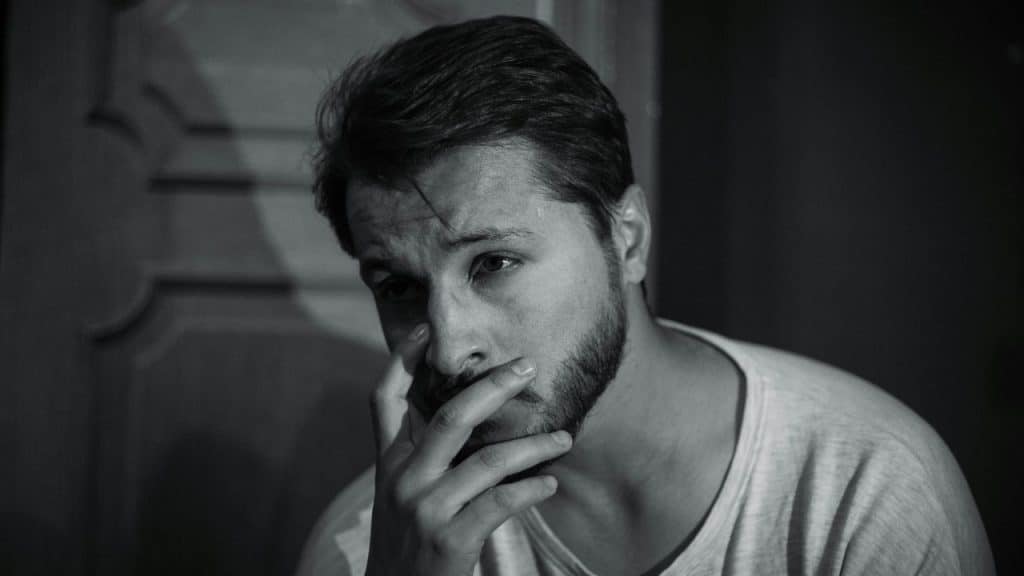 A man looking at someone, visibly hurt by what he sees.
