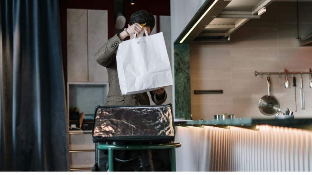 A man packing a small bag in a calm, reflective mood, ready to leave.