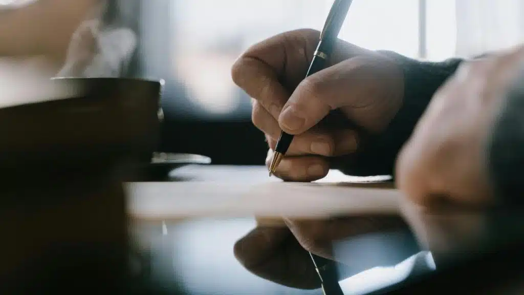 A man exploring personal emotional tools like journaling to manage stress.