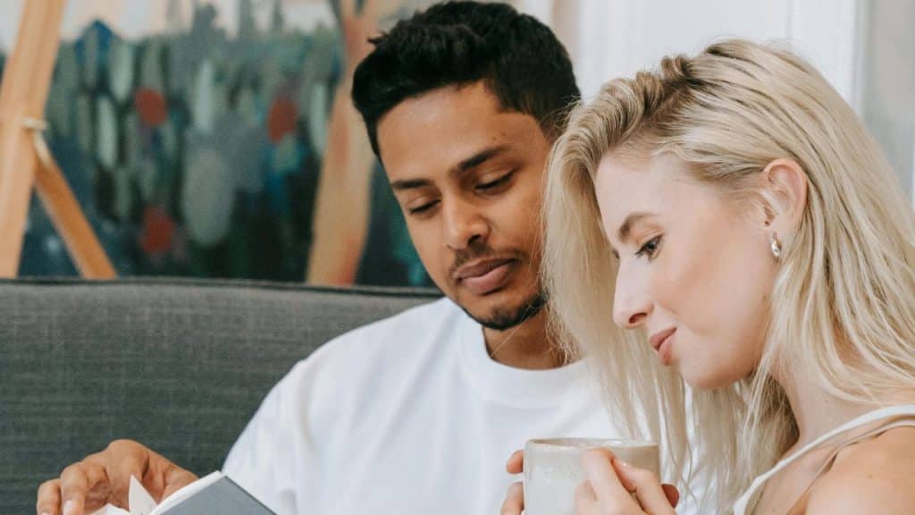 A couple reading peacefully together, reflecting patience and emotional support.