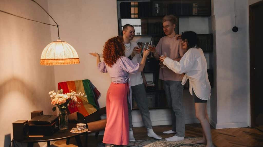 A group of friends gathered in a modern living room with custom cocktails and warm smiles.