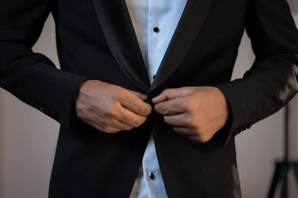 A man wearing a dark colored blazer.