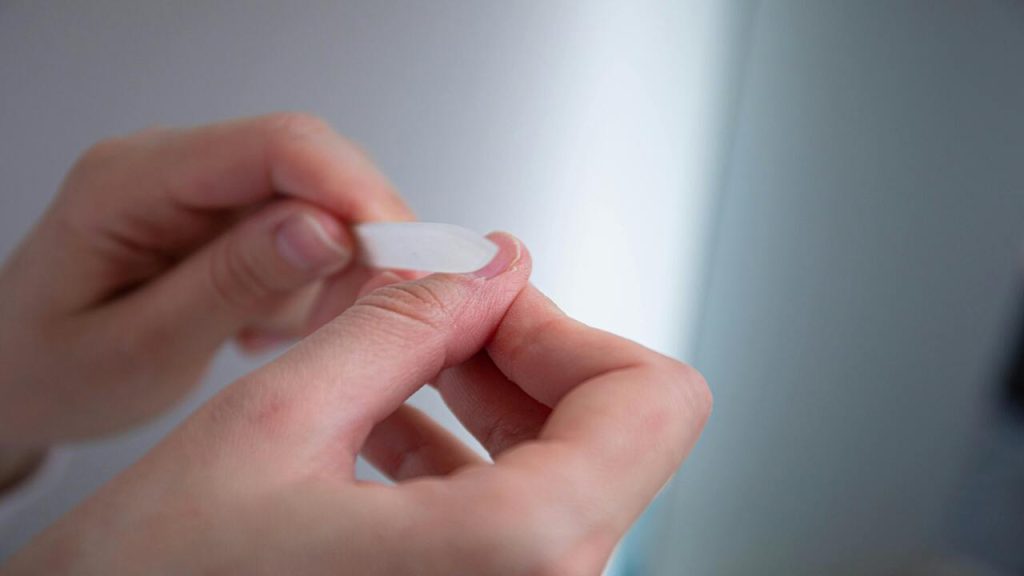 A person cleaning their nails.