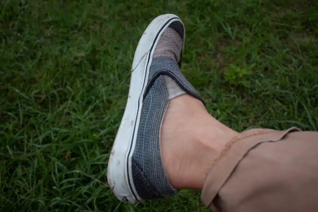 A picture of a person wearing a slipped-on shoes.