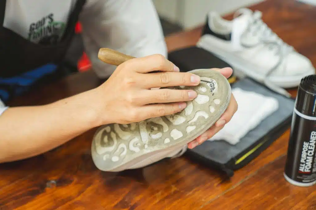 A man cleaning his shoes.
