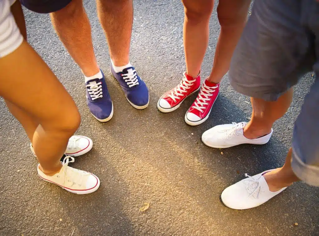 A picture of a people wearing a different shoes.