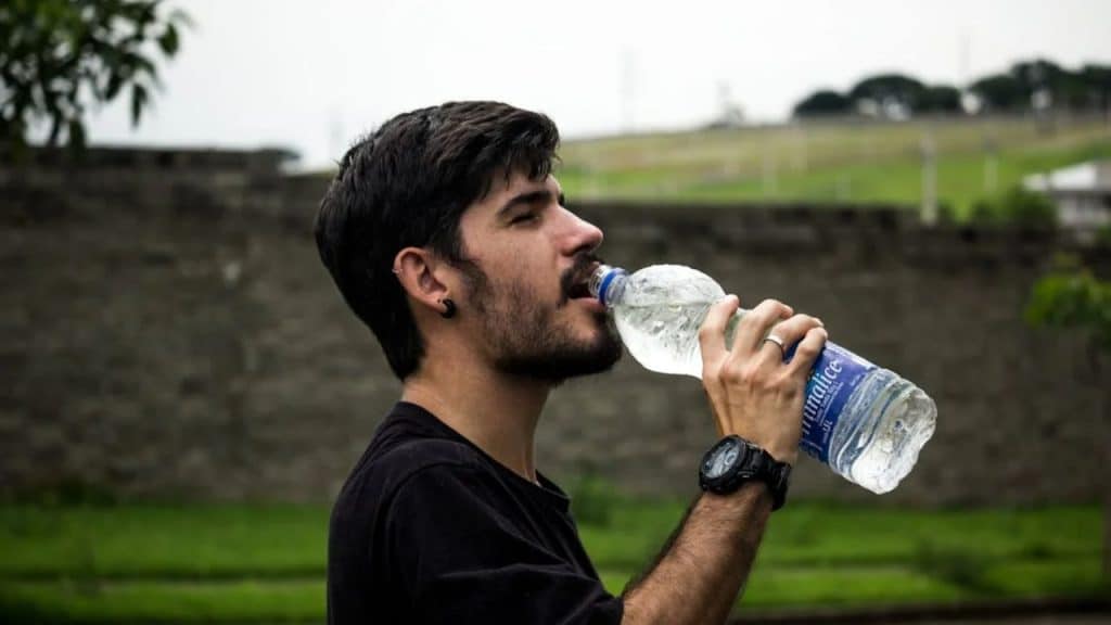 Man drinking water to limit liquid calorie intake.