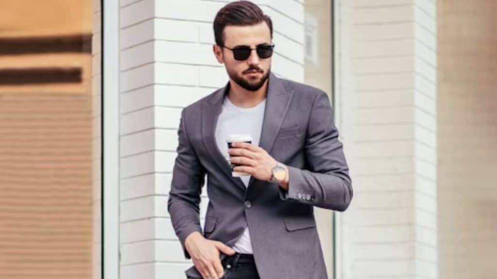 A man walking confidently wearing casual modern clothes.