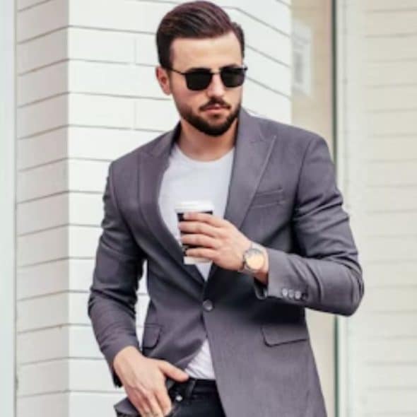 A man walking confidently wearing casual modern clothes.