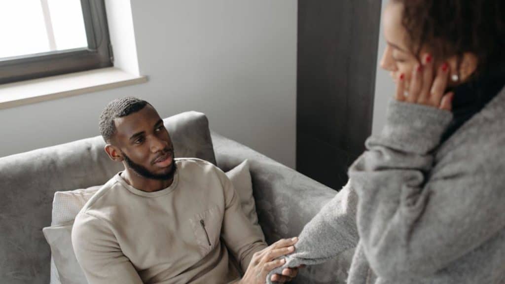 Man offering quiet emotional support to his partner without trying to fix her problems.