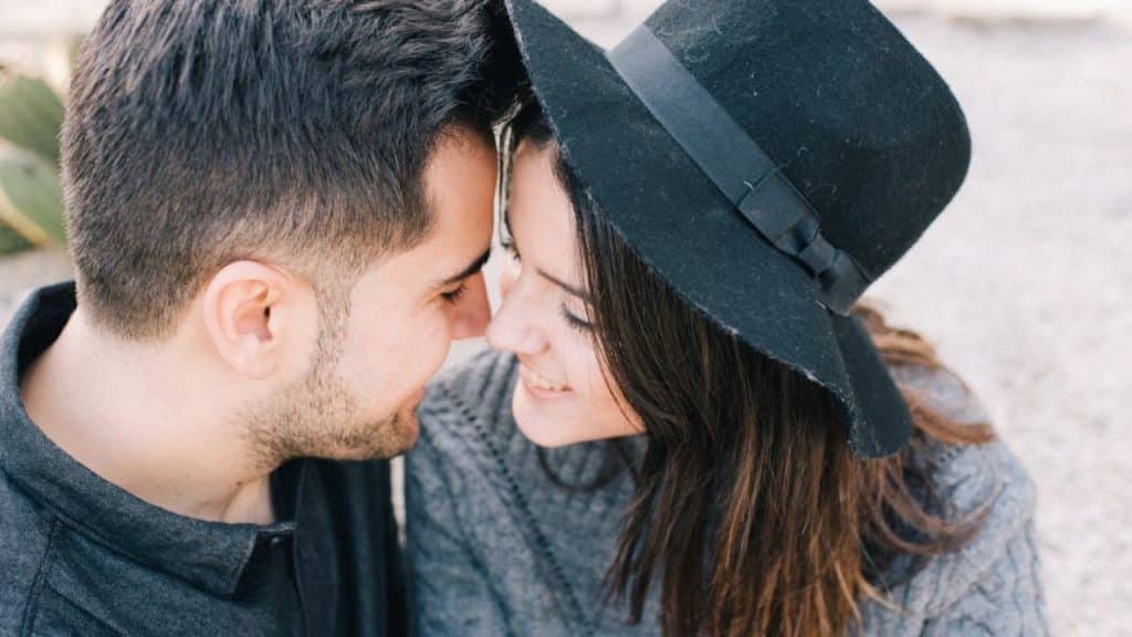 Man showing affection and emotional presence in a loving, balanced relationship.