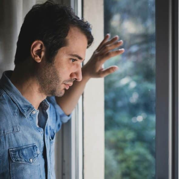 A man staring outside the window