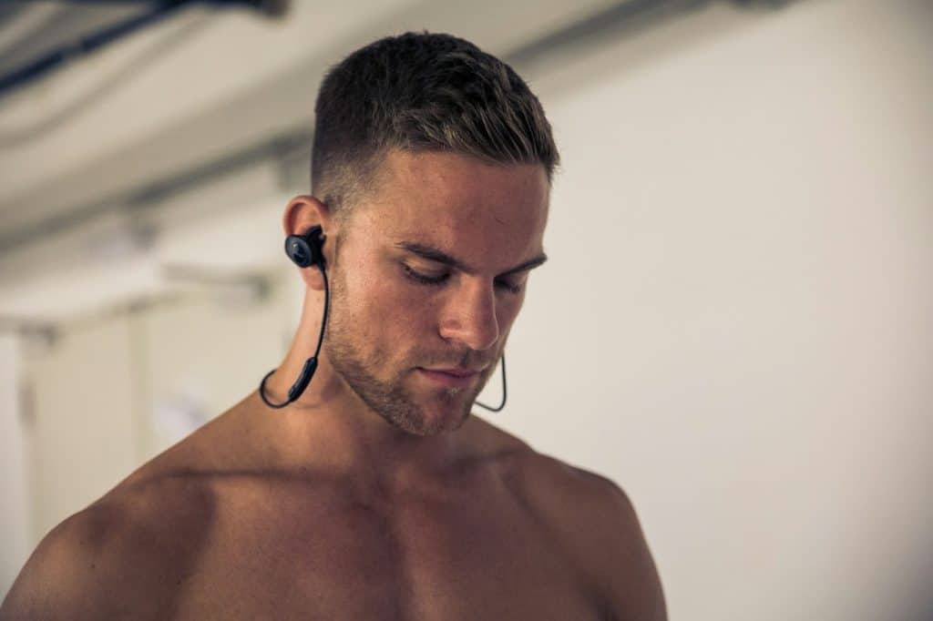 A man using a black earbuds