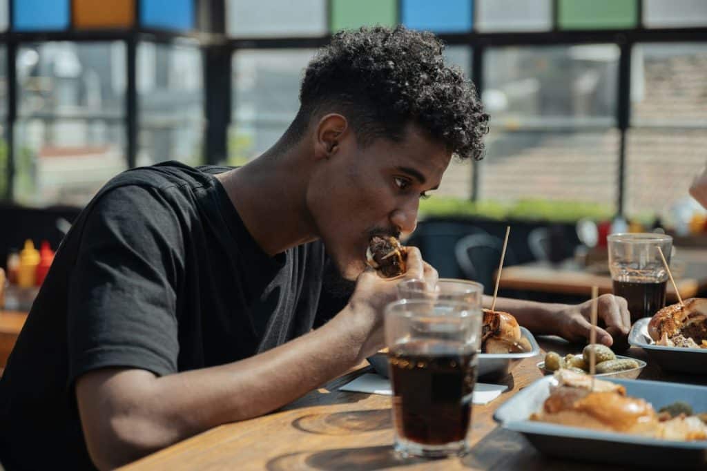 A man eating a food at the table.