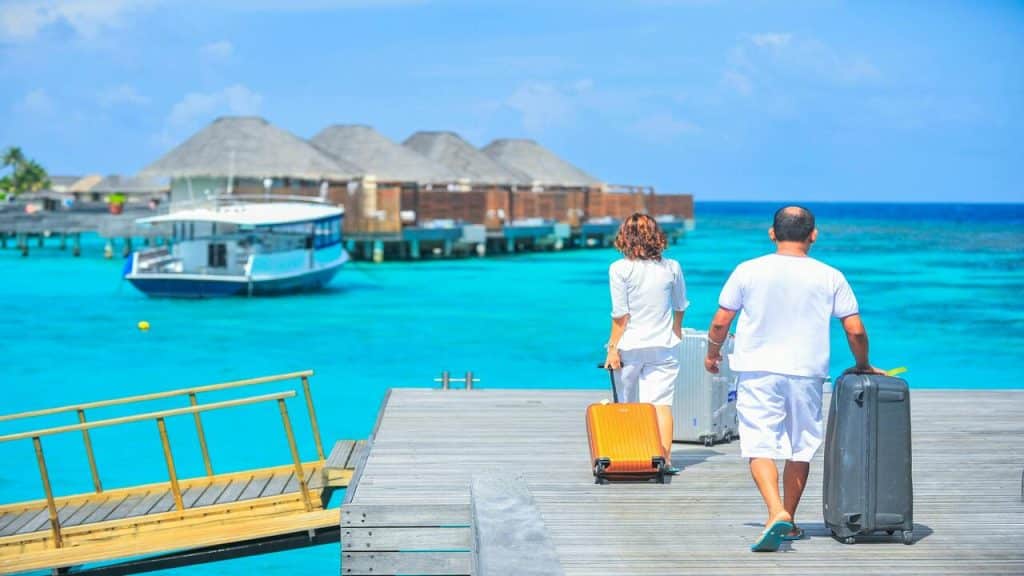 A couple walking on a dock on vacation.