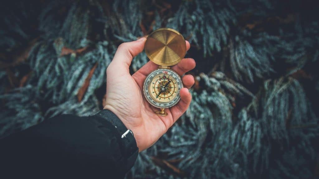 A man holding a compass.