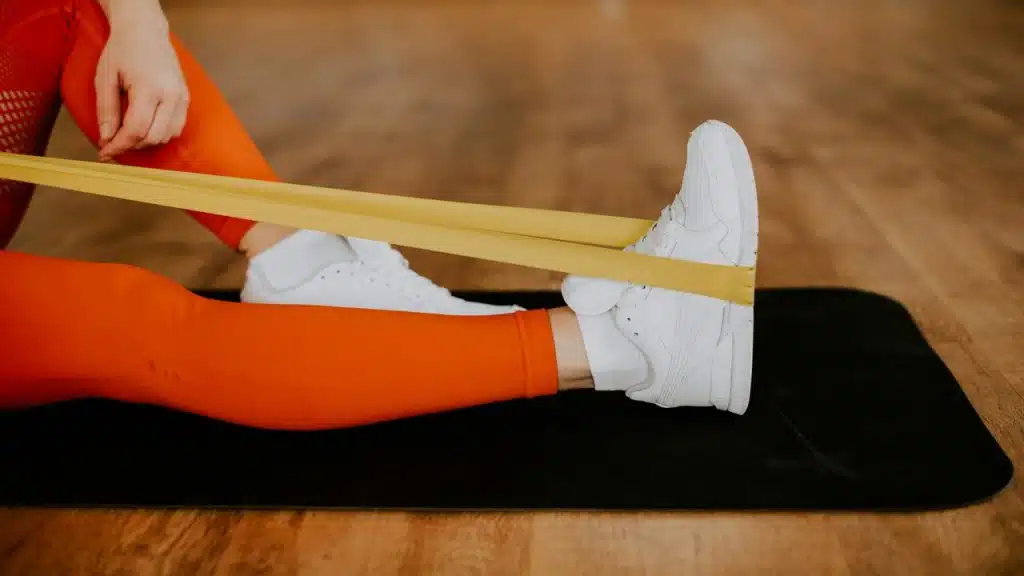 A woman using a resistance band.