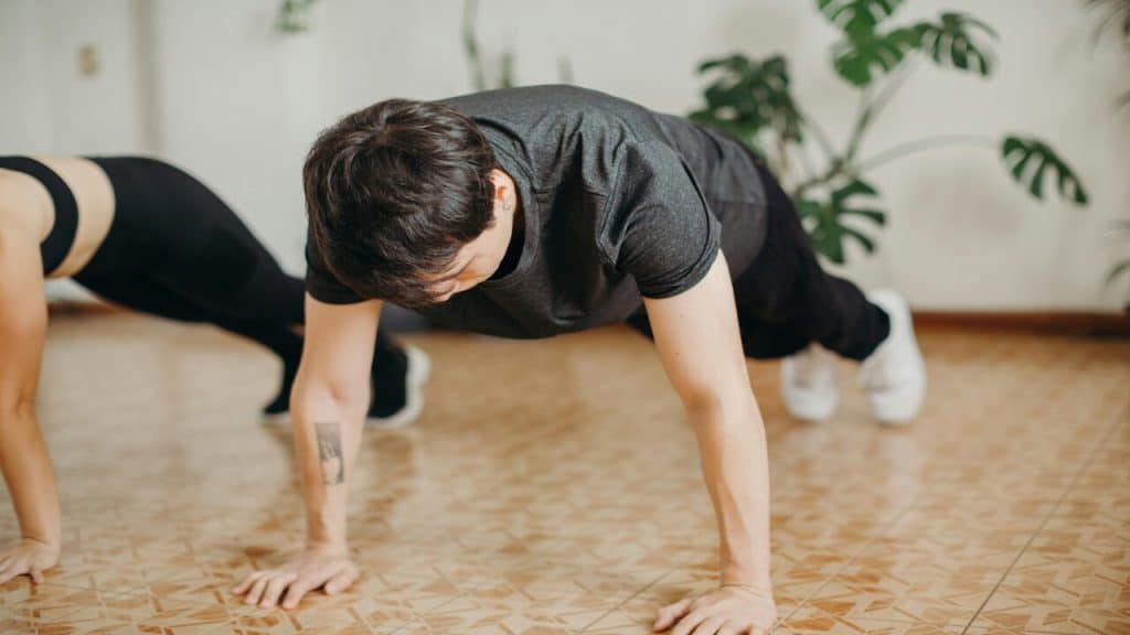 A man doing a push-up during a burpee.