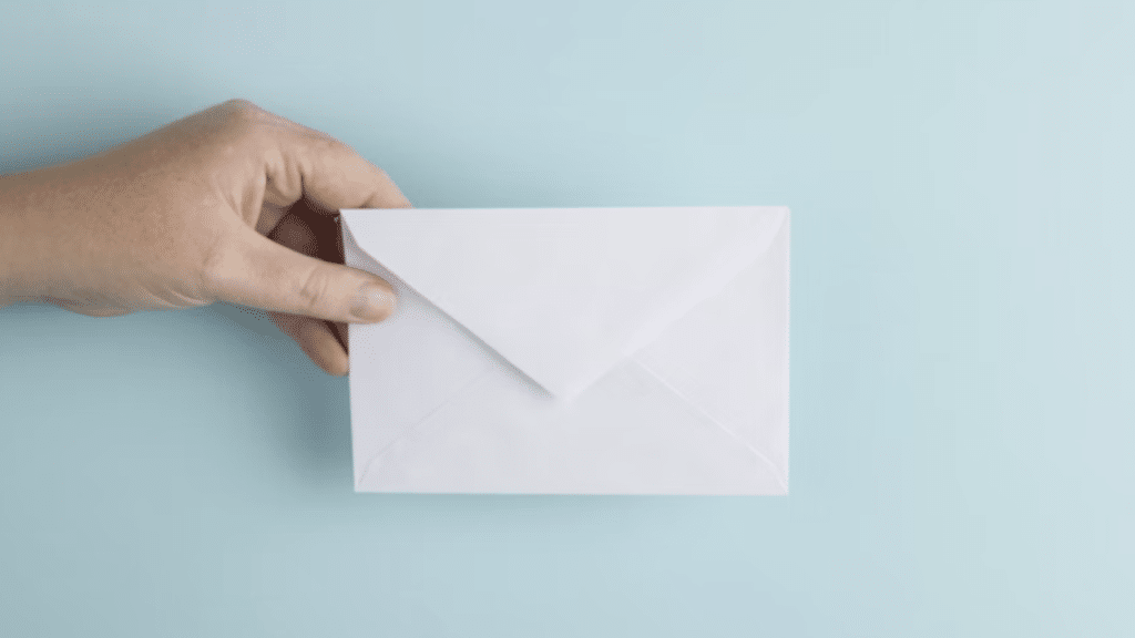 A hand holding an invitation