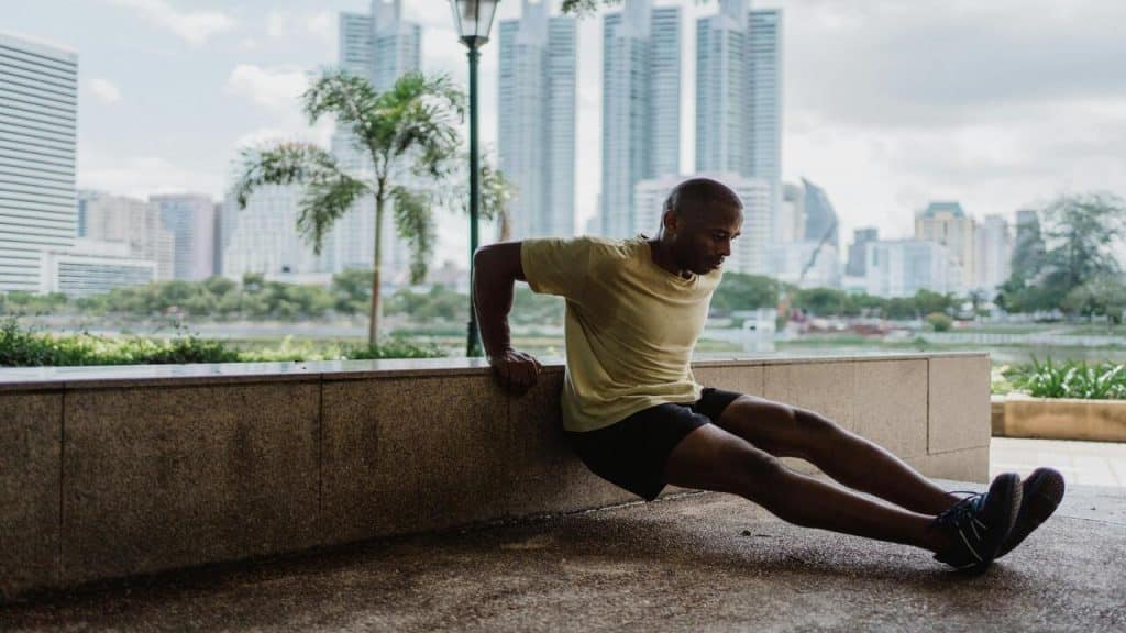 A man doing a tricep dip.
