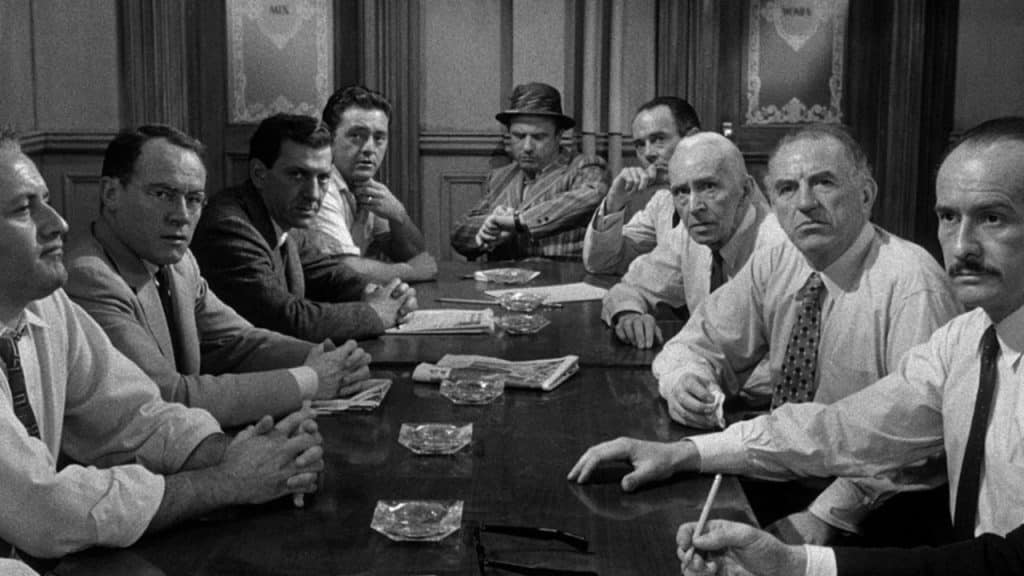 Nine male jury members looking serious.