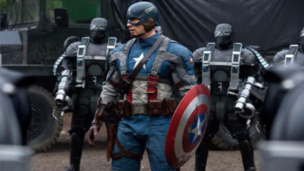 Captain America holding his shield in front of some masked men.
