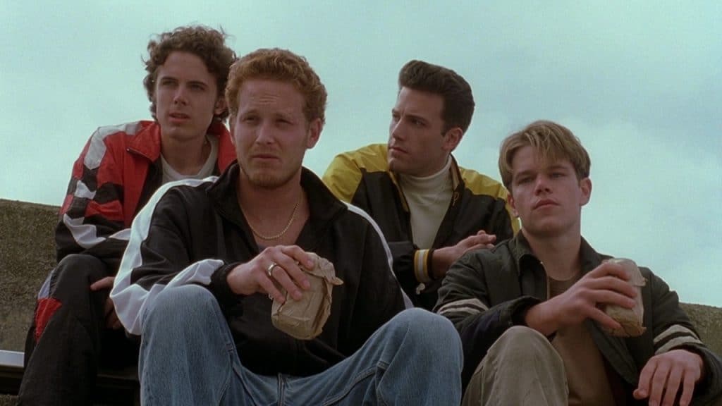 Four men sitting at a roof.