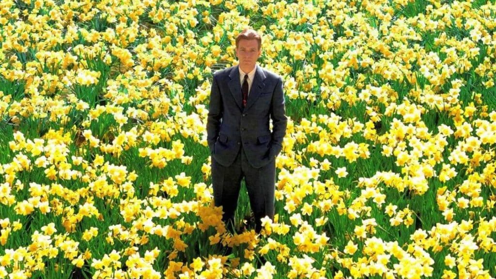 A man standing at a flower field.