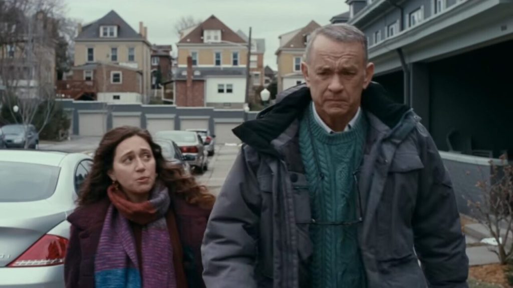 A man and a woman walking in the street.