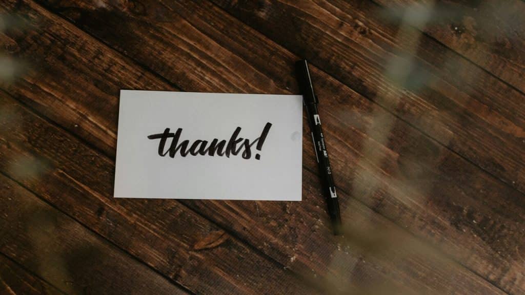 A thank you card on top of a wooden table