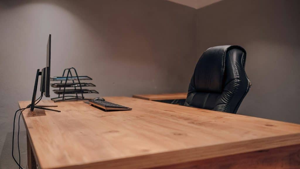 A desk that has nothing but computer and a keyboard