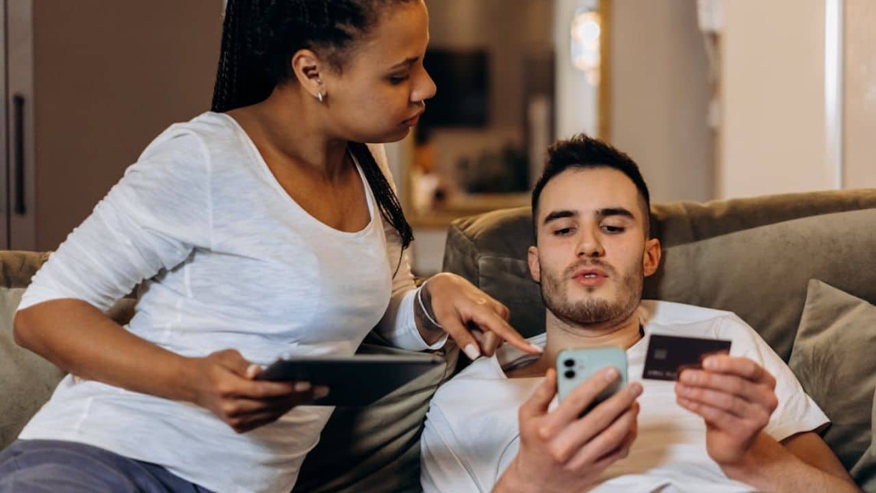 Man sharing phone content openly with partner to demonstrate transparency.